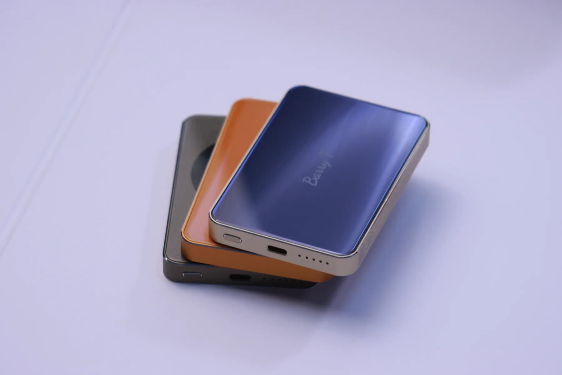 SZA POWER compact power banks in blue, orange, and dark finishes