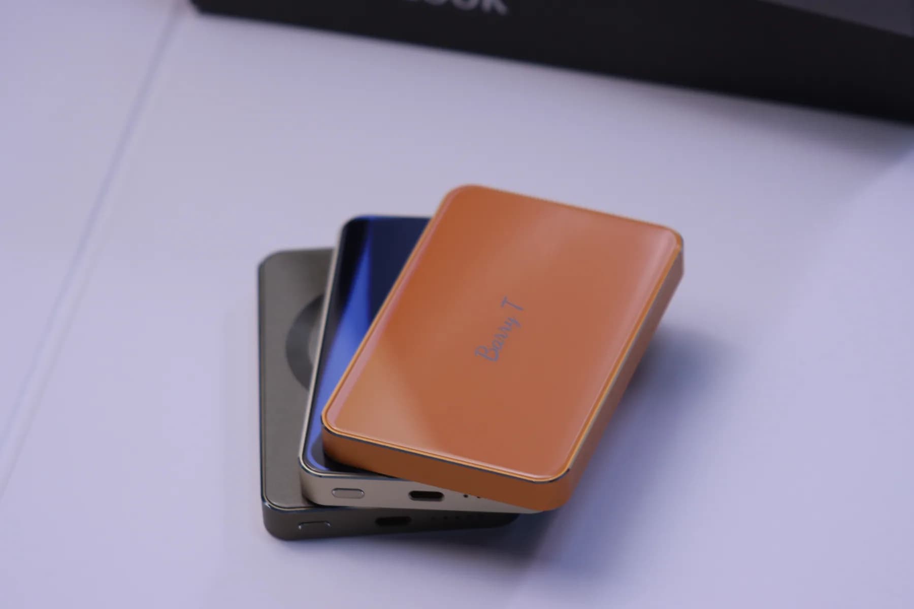 SZA POWER orange compact power bank stacked above blue and dark units