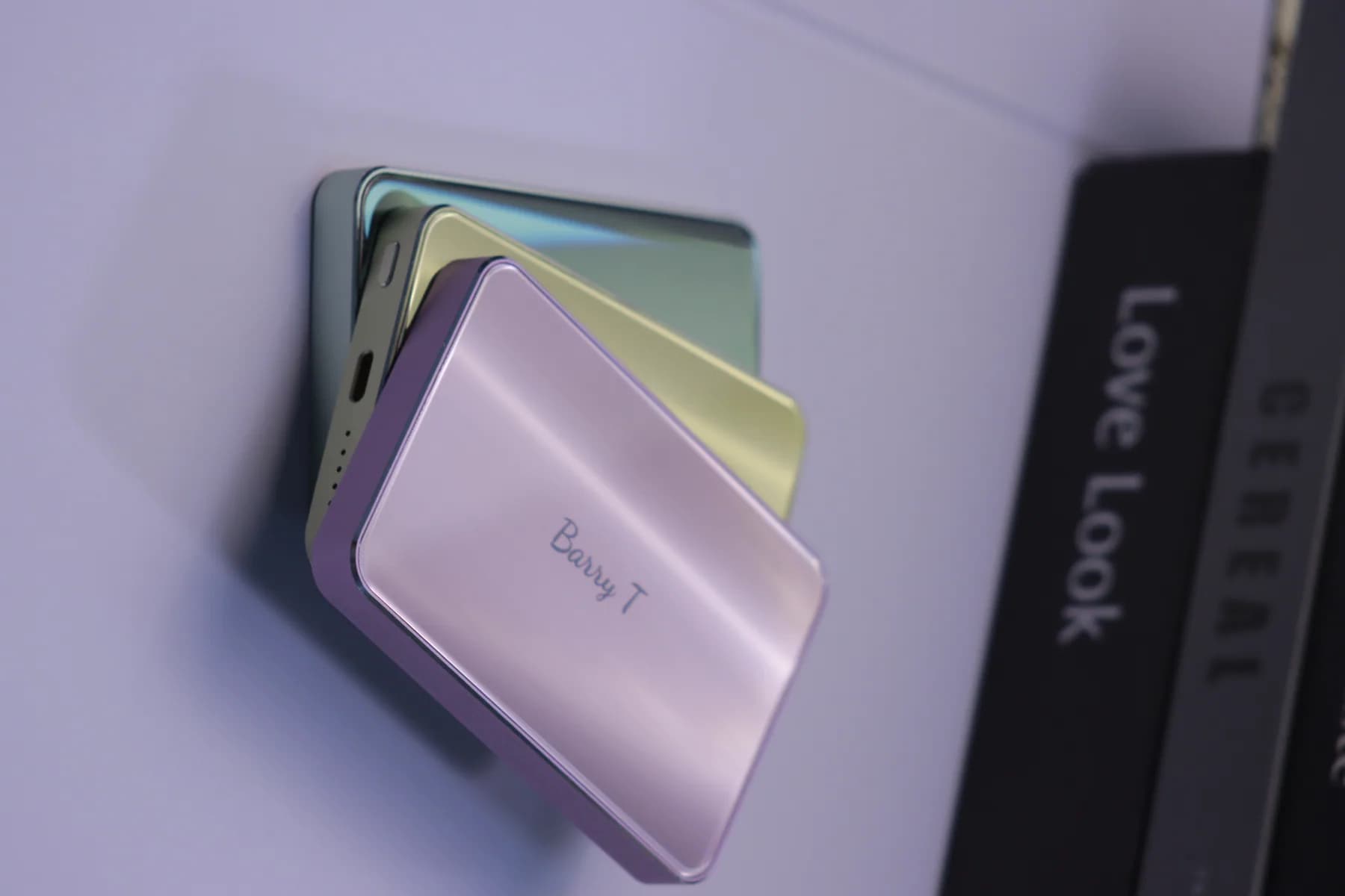 SZA POWER pastel compact power banks stacked on a display surface