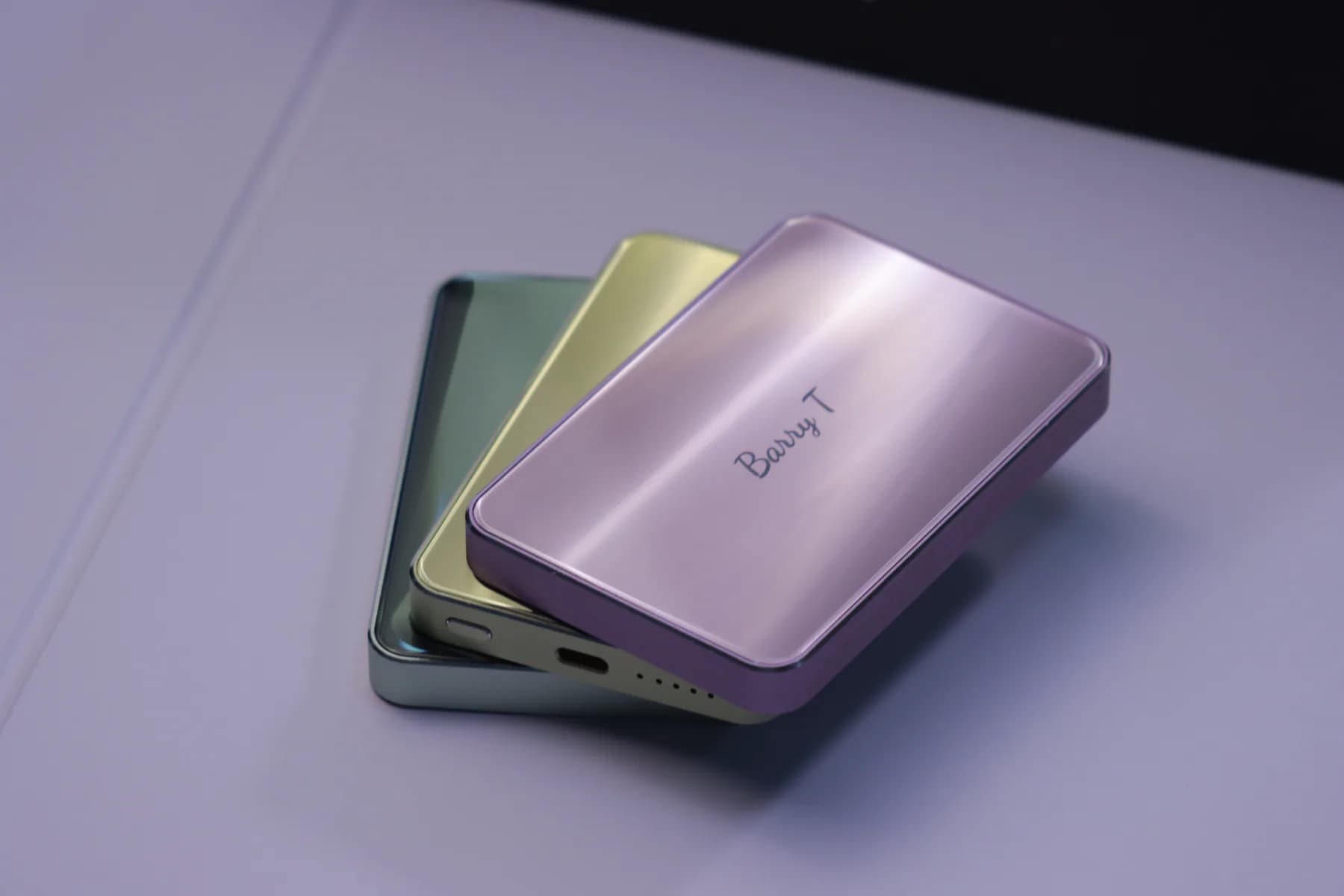 SZA POWER pink compact power bank with green and teal finishes behind it